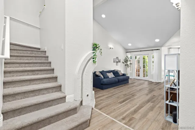 a living room with furniture and stairs