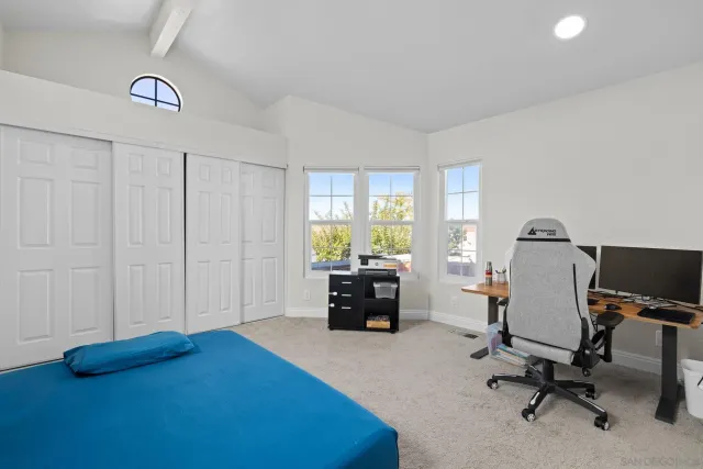 a view of a livingroom with workspace and a window