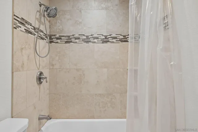 a bathroom with a shower and a toilet