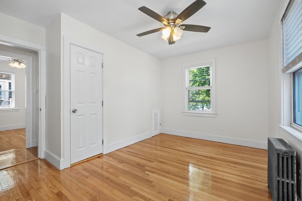 129 Virginia Road Waltham, MA 02453 - Photo 13 of 27 wooden floor in an empty room with a window
