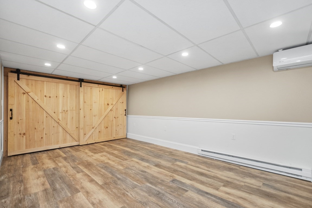129 Virginia Road Waltham, MA 02453 - Photo 23 of 27 an empty room with wooden floor and white walls