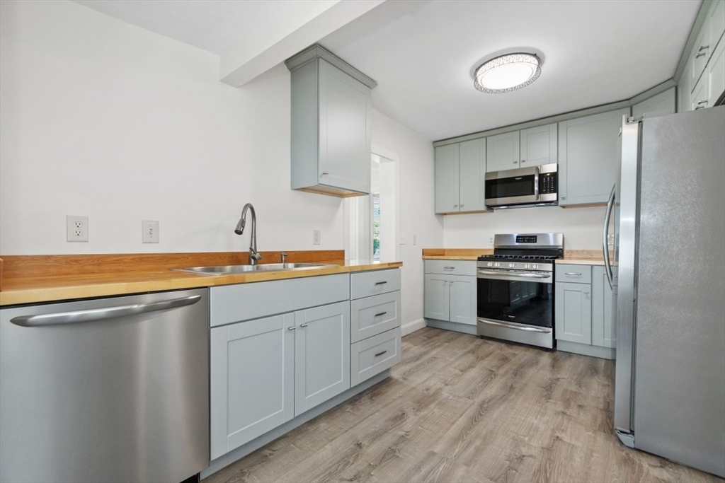 129 Virginia Road Waltham, MA 02453 - Photo 3 of 27 a kitchen with a sink cabinets and stainless steel appliances