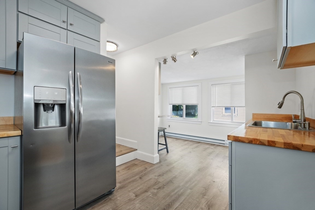 129 Virginia Road Waltham, MA 02453 - Photo 5 of 27 a kitchen with granite countertop a refrigerator and a sink