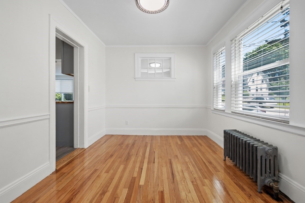 129 Virginia Road Waltham, MA 02453 - Photo 10 of 27 a view of a room with wooden floor and small window