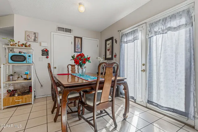 a living room with furniture a flowers and a flat screen tv
