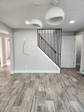 a view of a room with wooden floor and windows