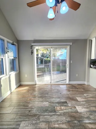 a view of empty room with wooden floor
