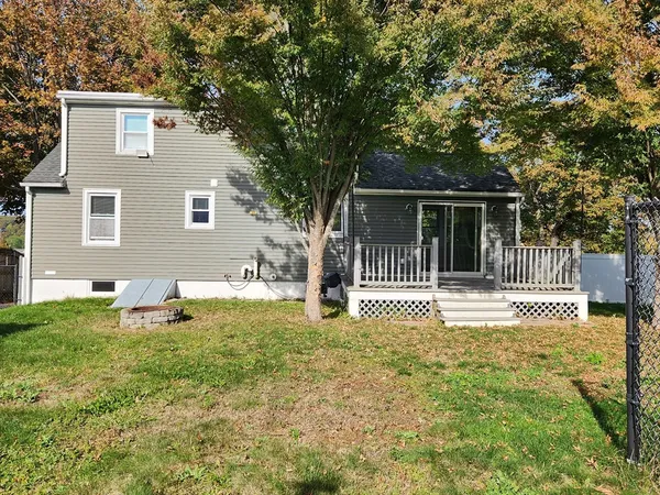 a front view of a house with a yard table and chair