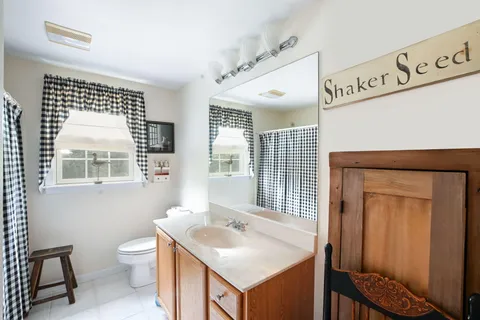 a view of a house with backyard sitting area and garden