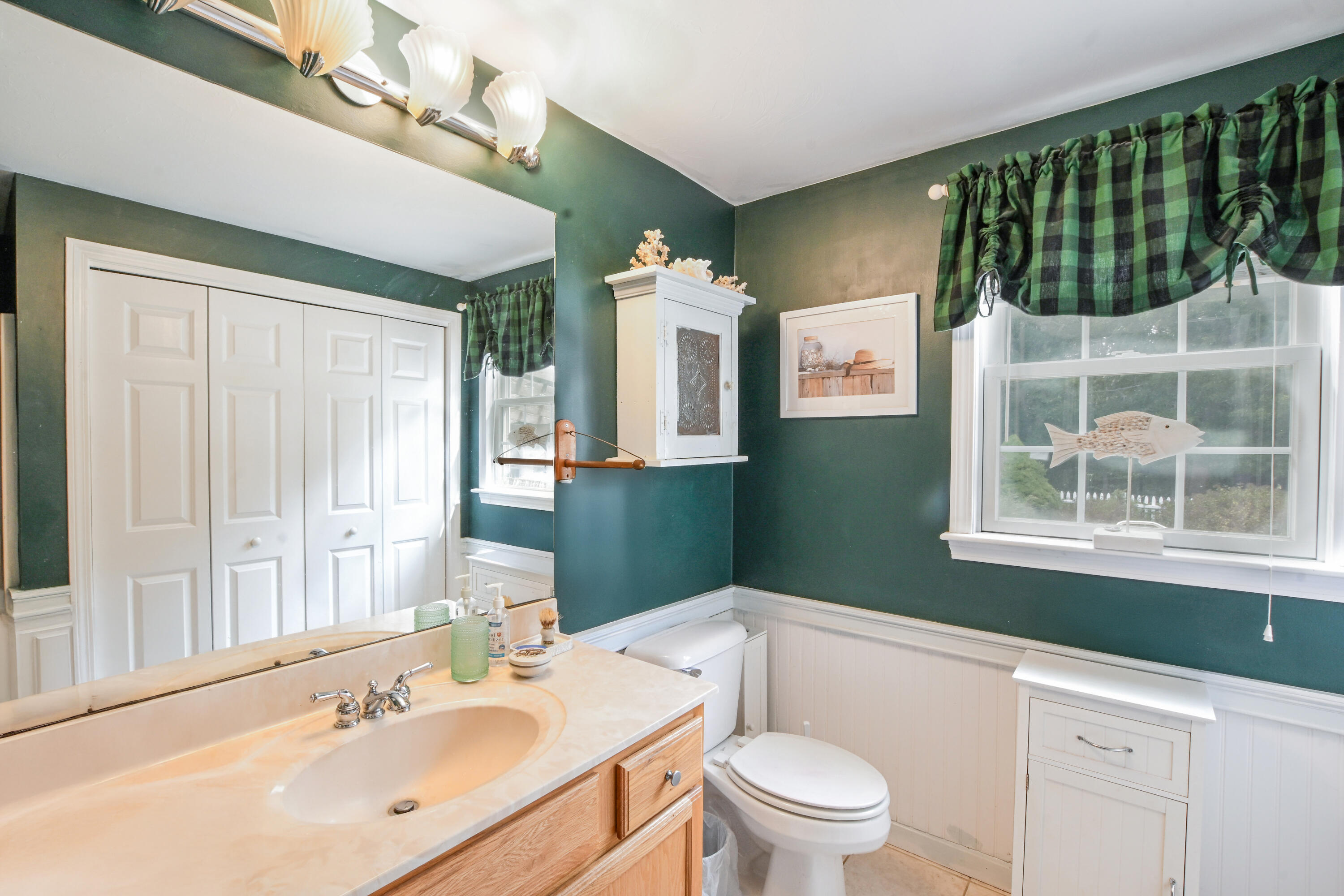 25 Harris Hill Road East Falmouth, MA 02536 - Photo 20 of 37 a bathroom with a sink a toilet and a mirror