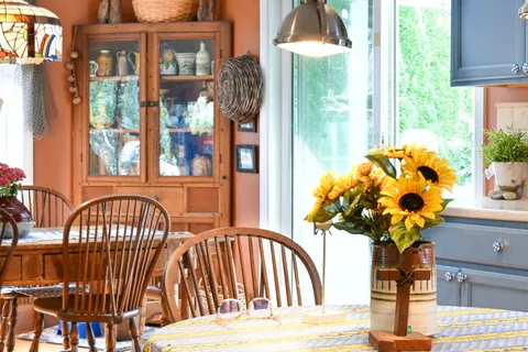 a view of house with a big yard and large trees