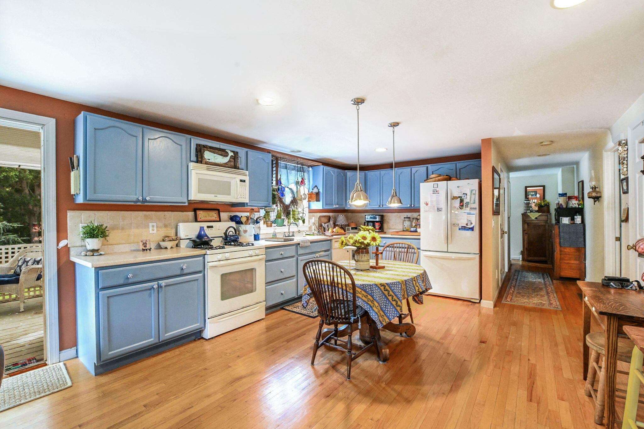 25 Harris Hill Road East Falmouth, MA 02536 - Photo 10 of 37 a kitchen with a table chairs refrigerator and cabinets