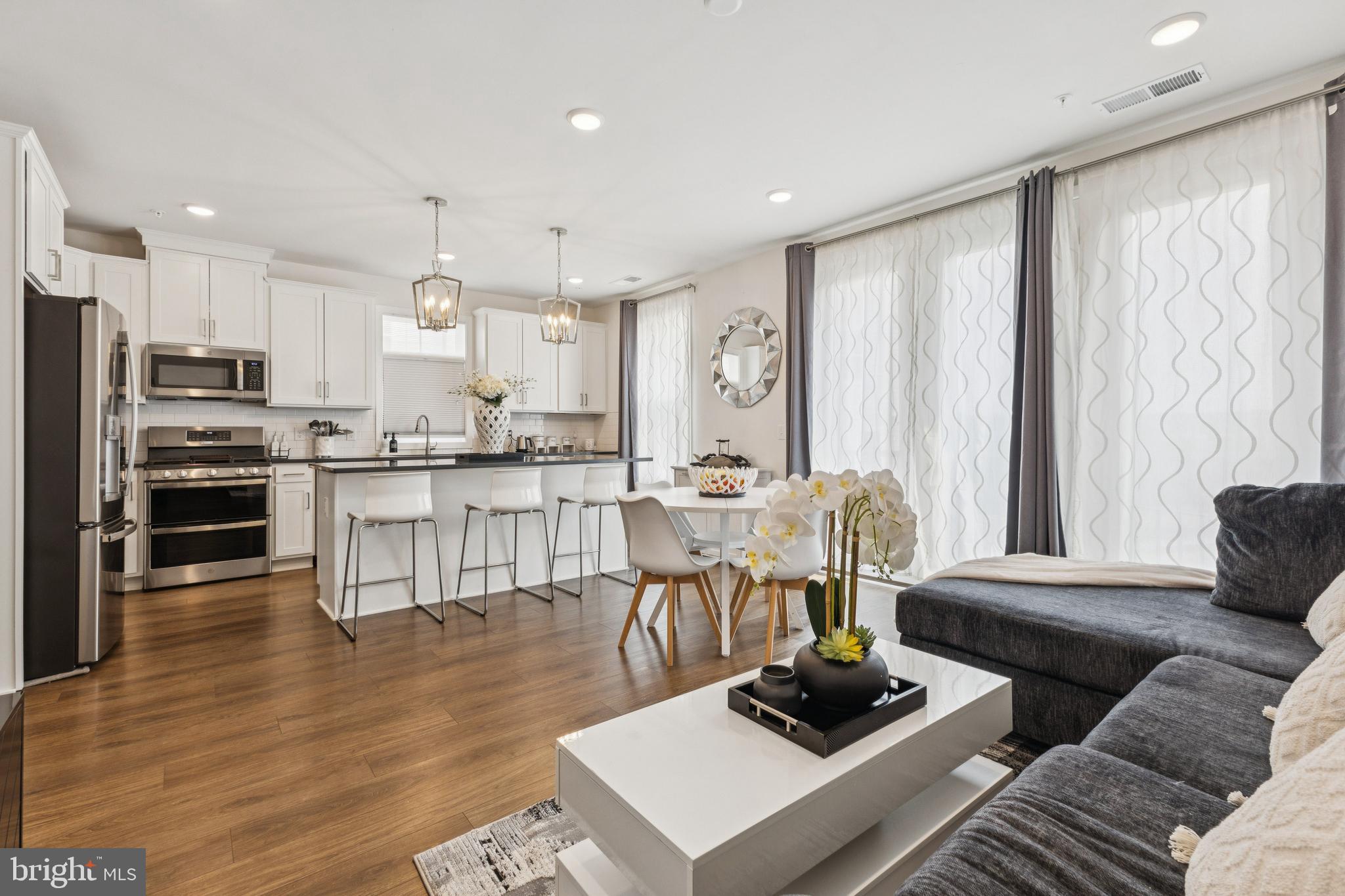 42597 Nubbins Terrace Ashburn, VA 20147 - Photo 11 of 40 a living room with furniture and a wooden floor