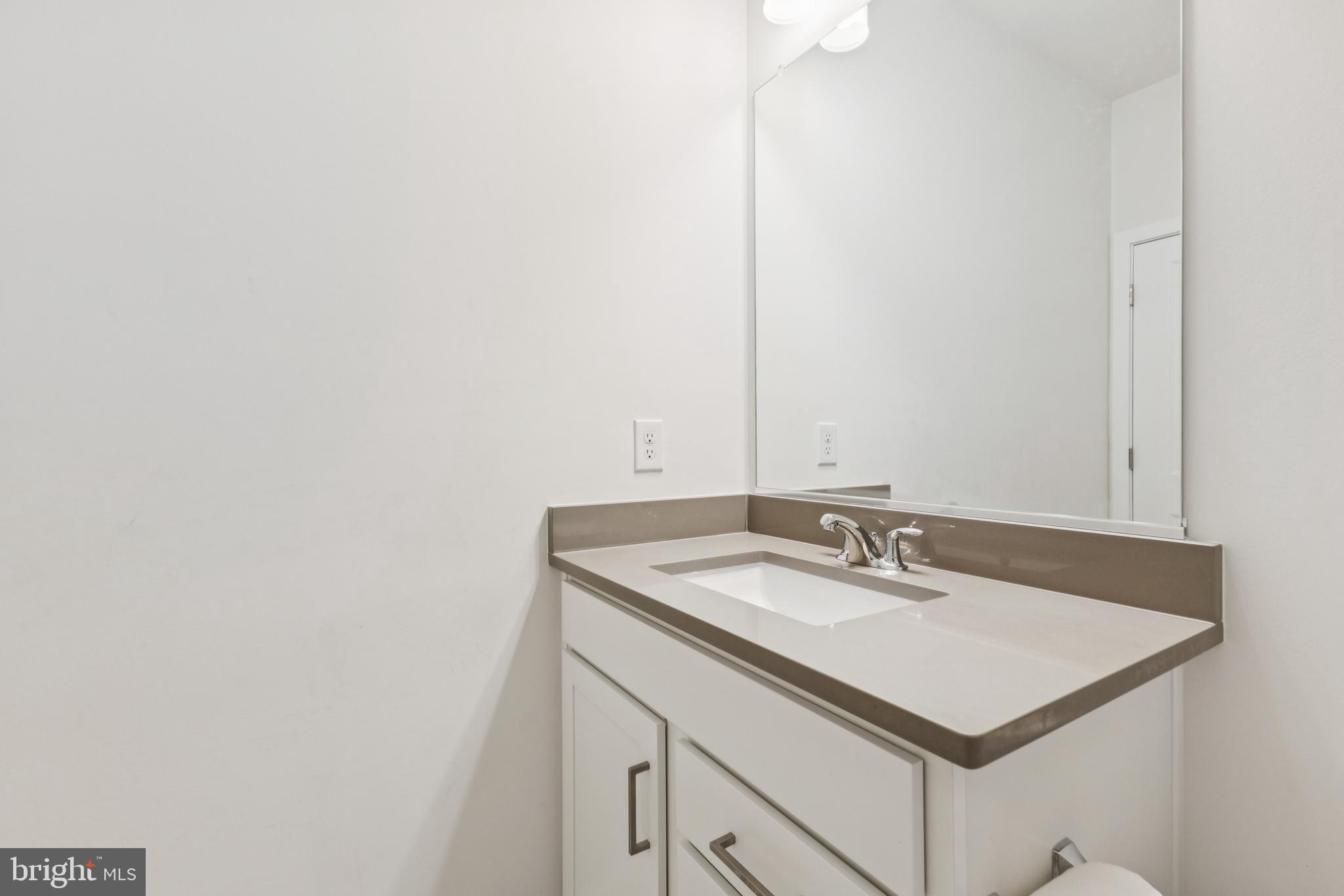 42597 Nubbins Terrace Ashburn, VA 20147 - Photo 20 of 40 a bathroom with a sink and a mirror