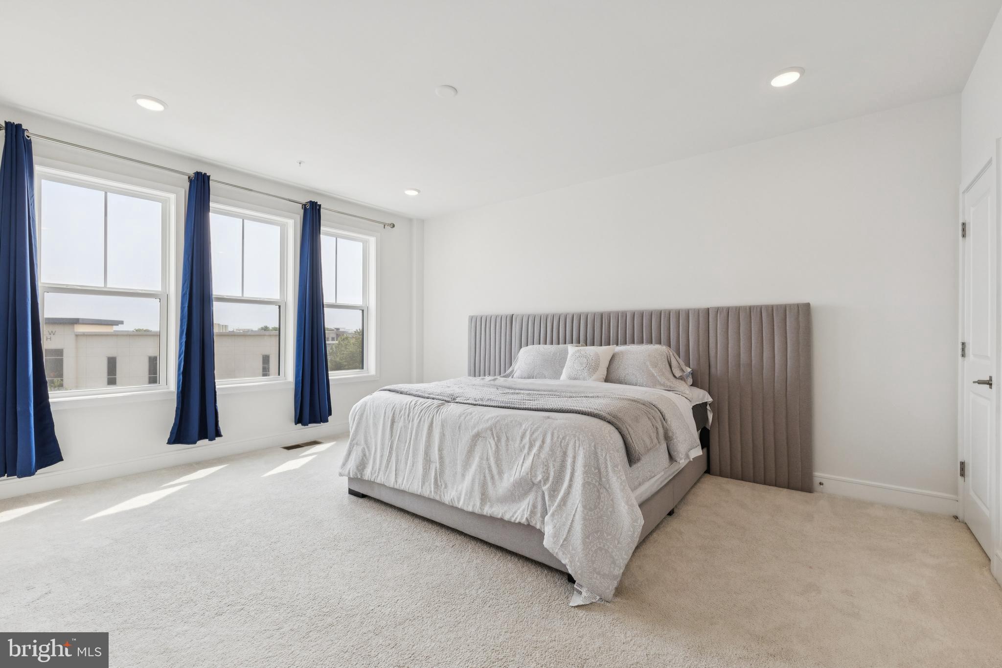 42597 Nubbins Terrace Ashburn, VA 20147 - Photo 21 of 40 a spacious bedroom with a large bed and a large window