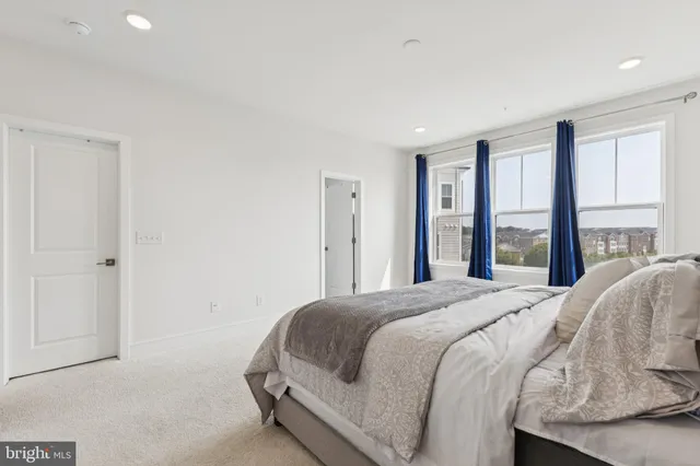 a bedroom with a bed and a large window