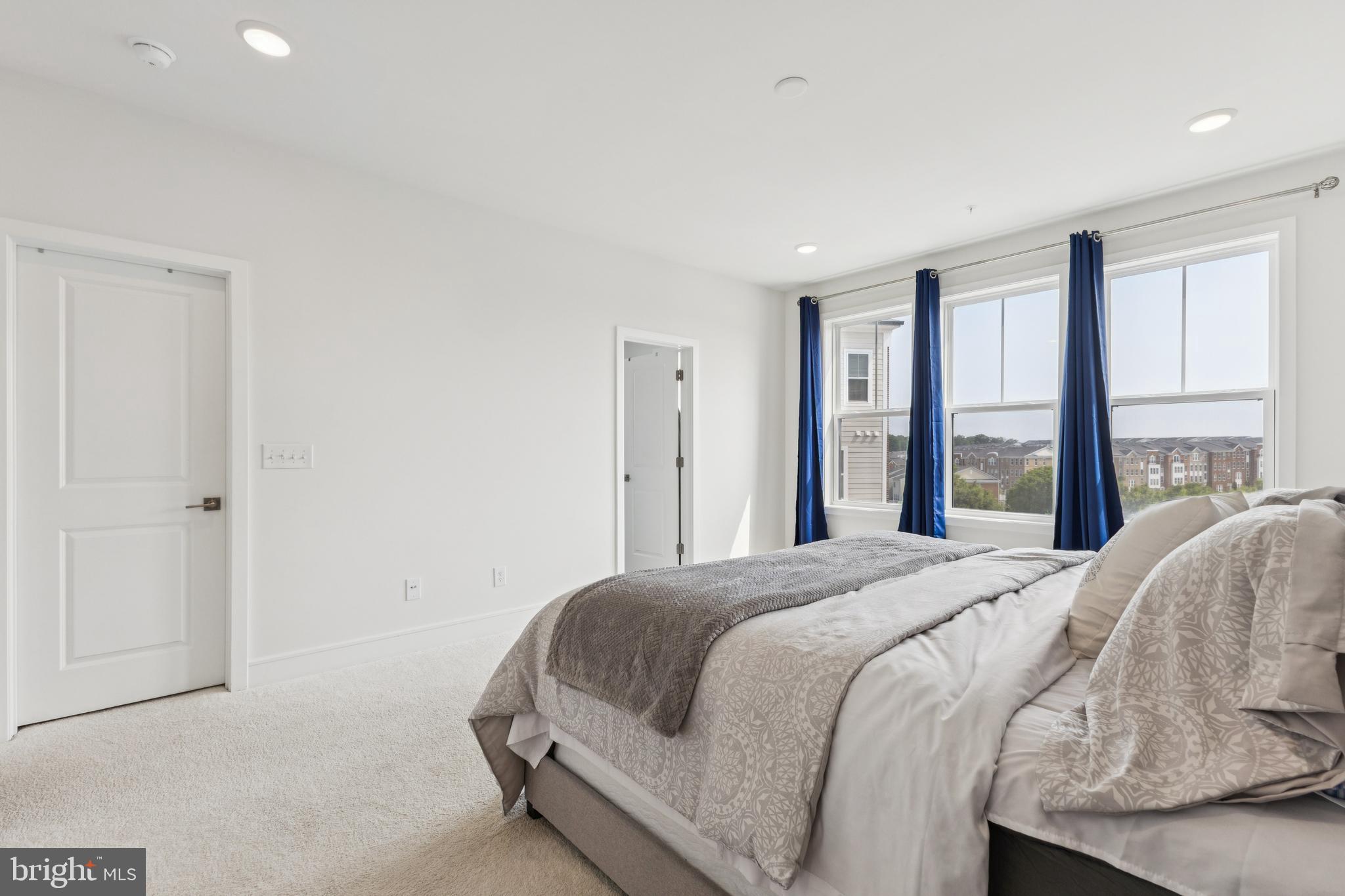 42597 Nubbins Terrace Ashburn, VA 20147 - Photo 22 of 40 a bedroom with a bed and a large window