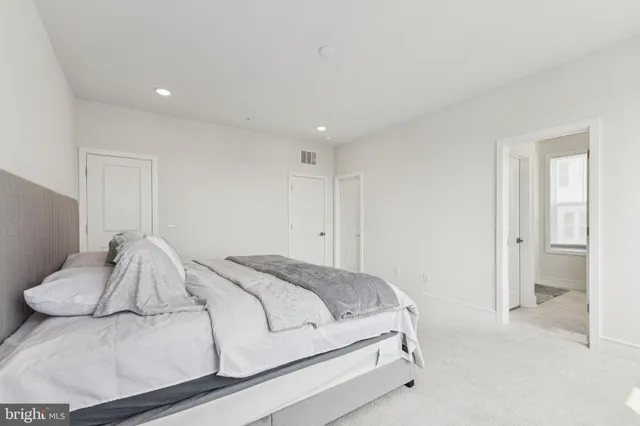 a bedroom with a bed and a couch