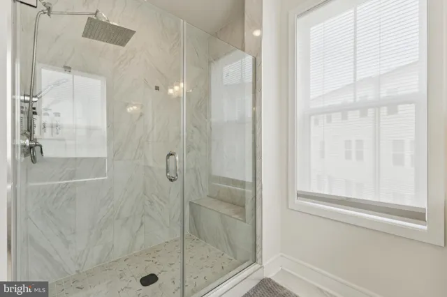 a bathroom with a glass shower door