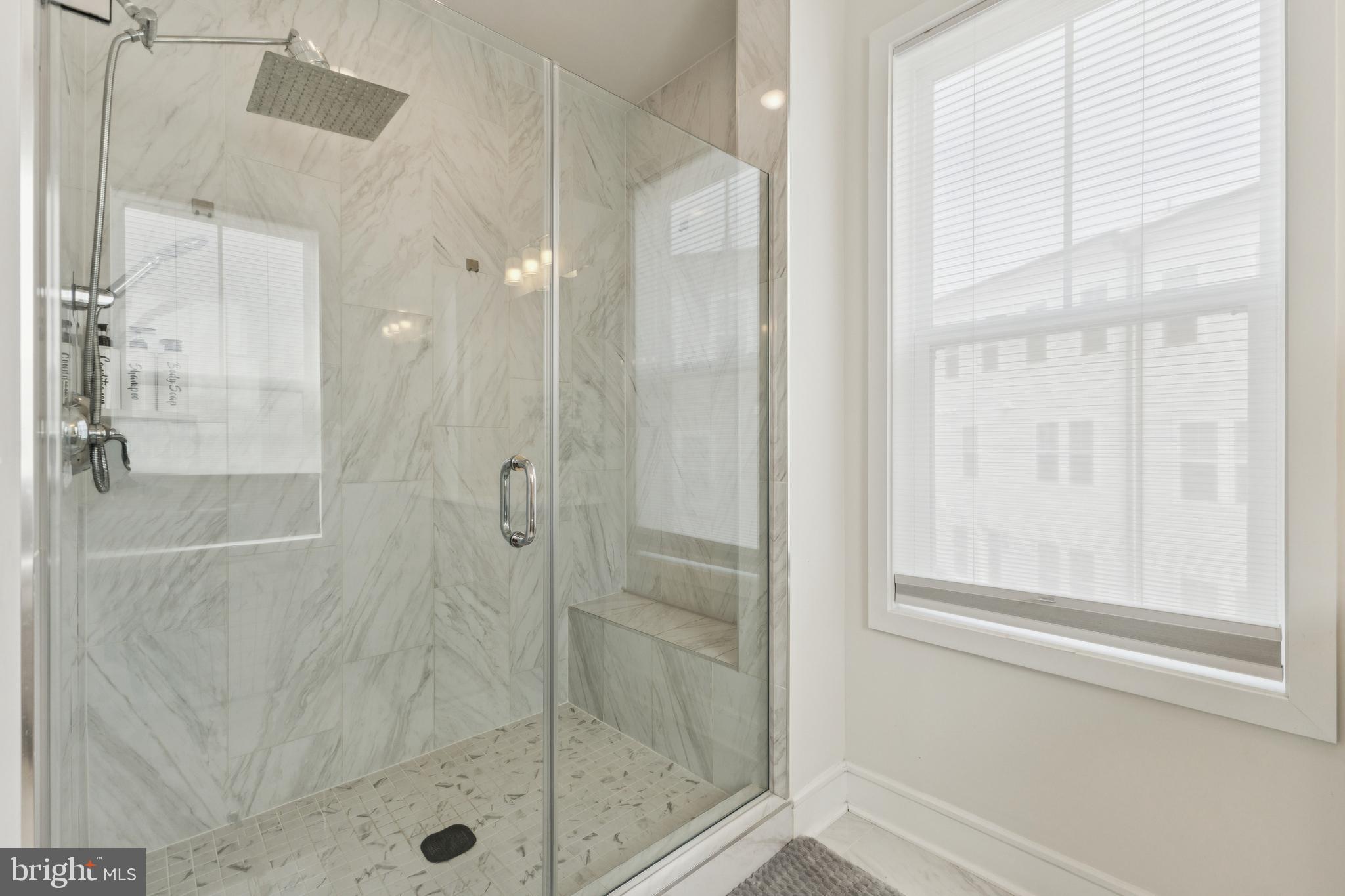 42597 Nubbins Terrace Ashburn, VA 20147 - Photo 27 of 40 a bathroom with a glass shower door