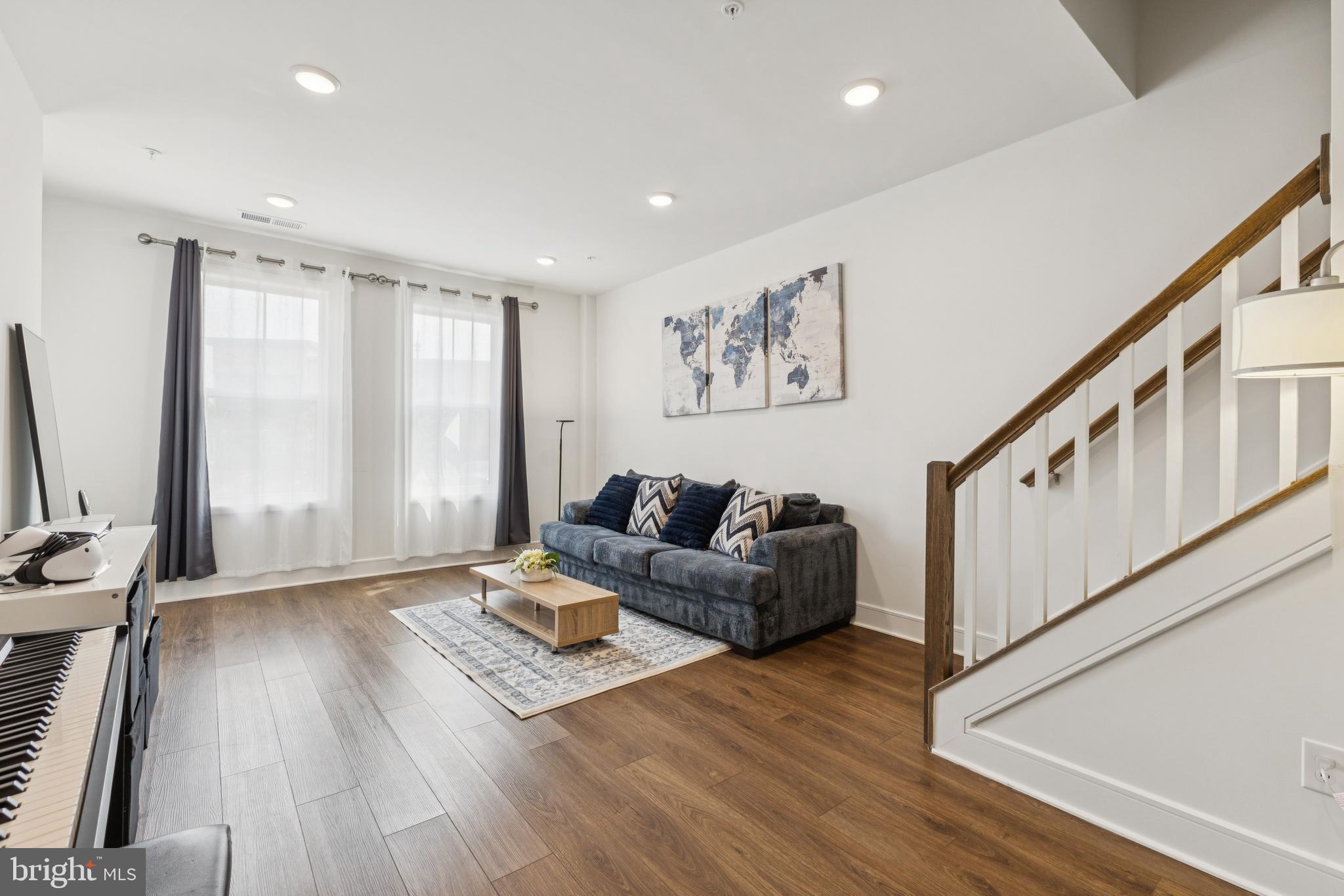 42597 Nubbins Terrace Ashburn, VA 20147 - Photo 3 of 40 a living room with furniture and wooden floor