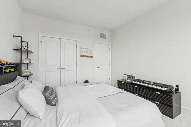 a bedroom with a bed and a potted plant