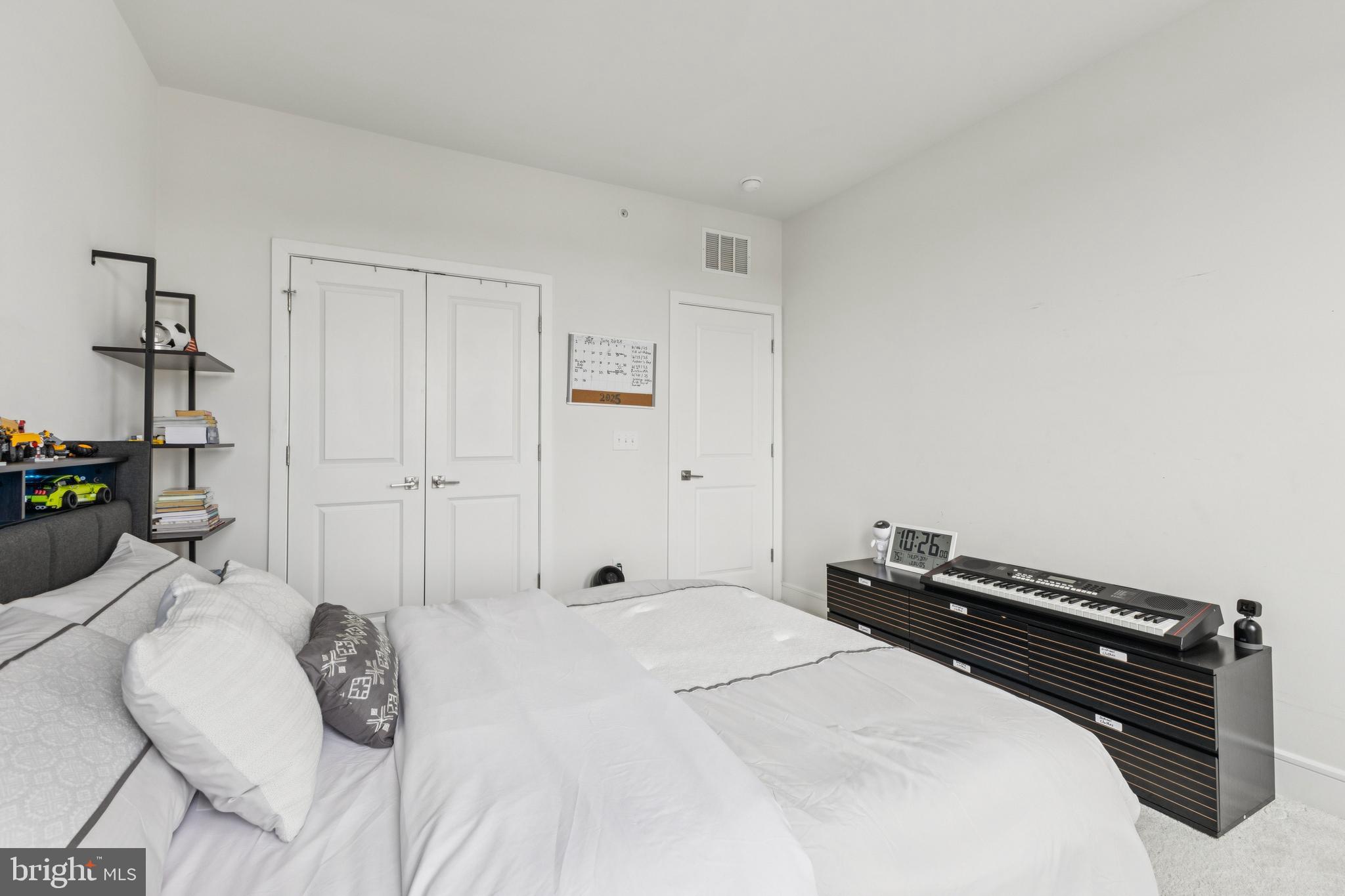 42597 Nubbins Terrace Ashburn, VA 20147 - Photo 32 of 40 a bedroom with a bed and a potted plant