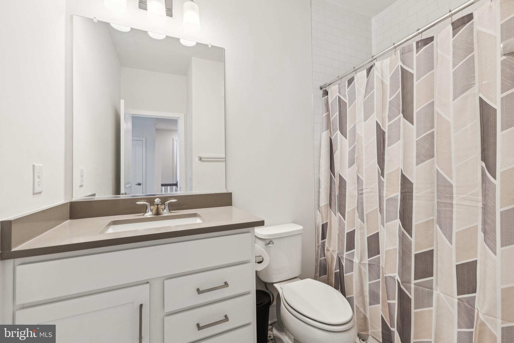 42597 Nubbins Terrace Ashburn, VA 20147 - Photo 33 of 40 a bathroom with a granite countertop sink a toilet and a mirror