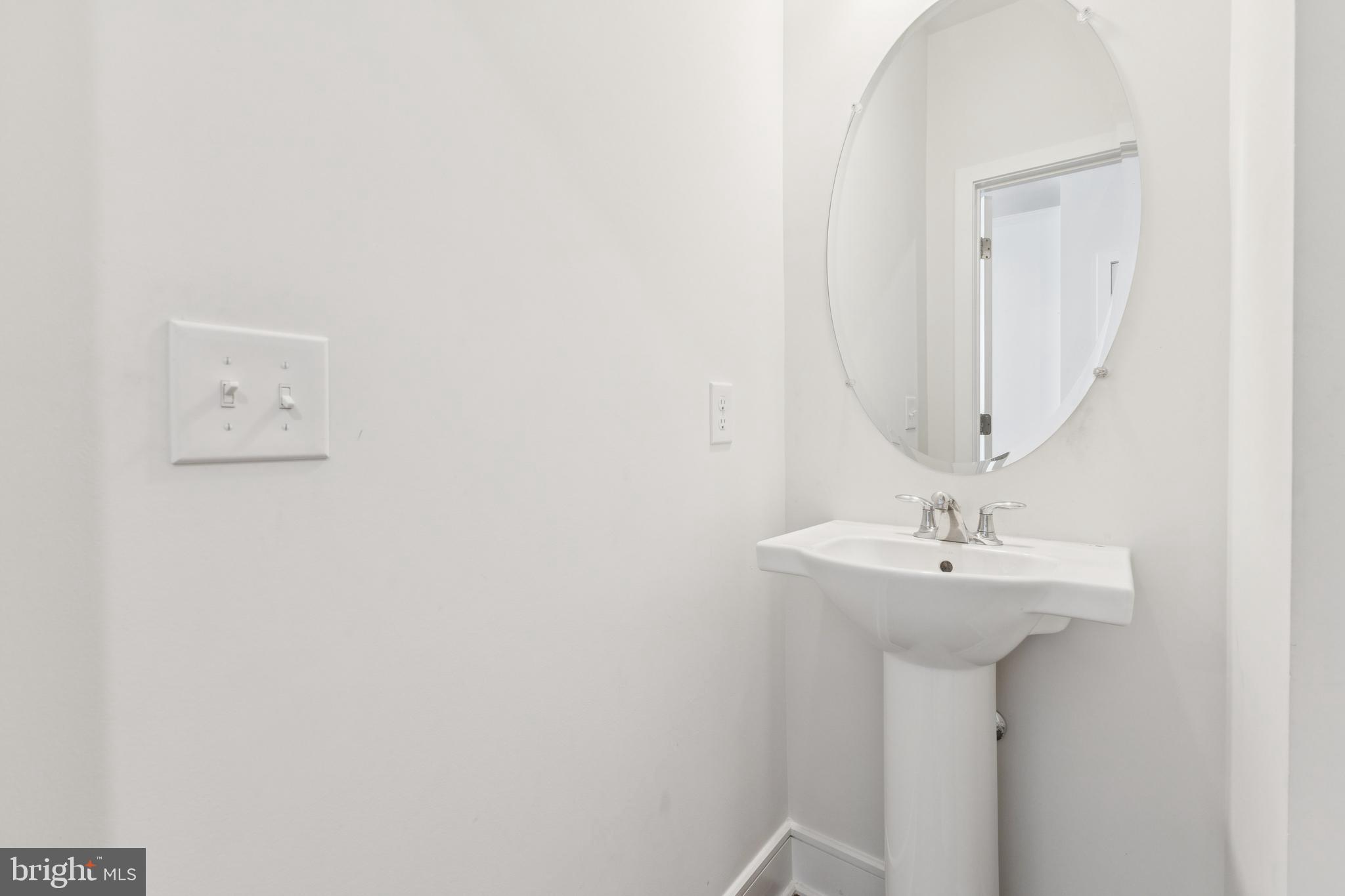 42597 Nubbins Terrace Ashburn, VA 20147 - Photo 37 of 40 a bathroom with a sink and a mirror