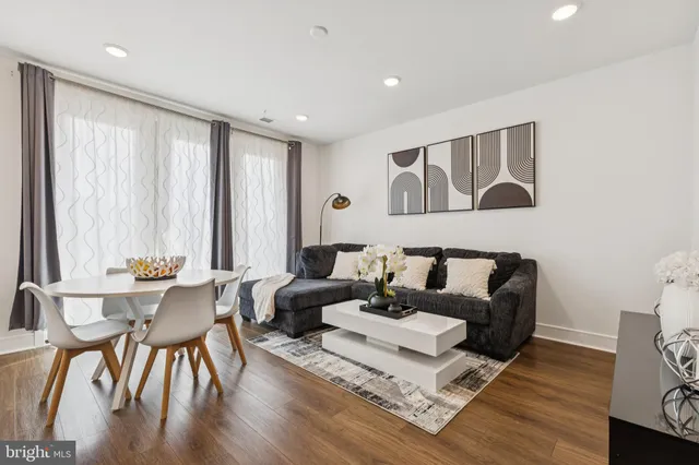a living room with furniture and wooden floor