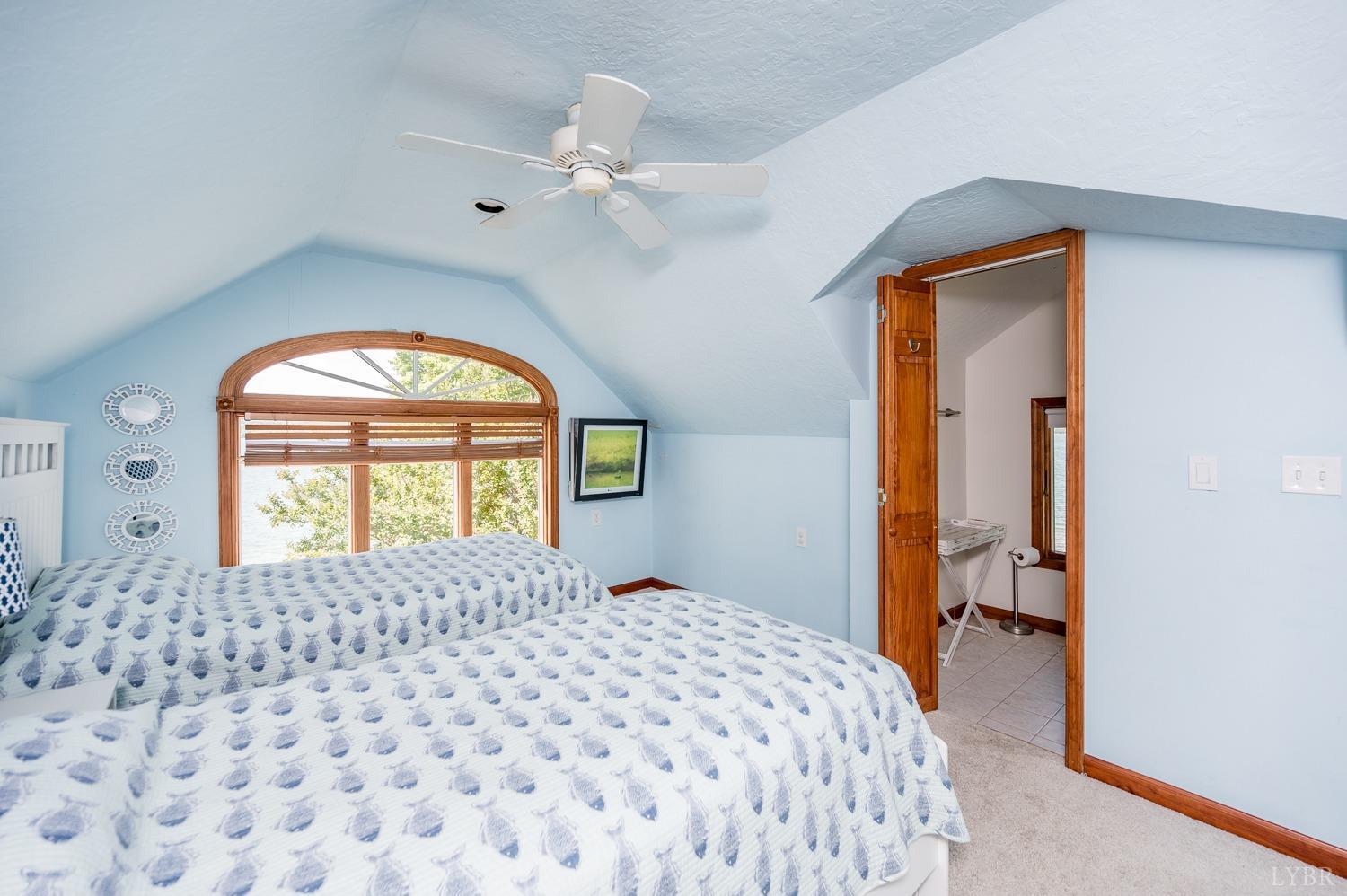 311 Anthony Home Road Huddleston, VA 24104 - Photo 21 of 70 a bedroom with a bed and a chandelier