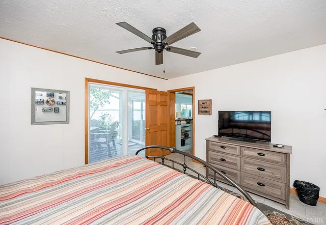 a living room with a large window and a bed