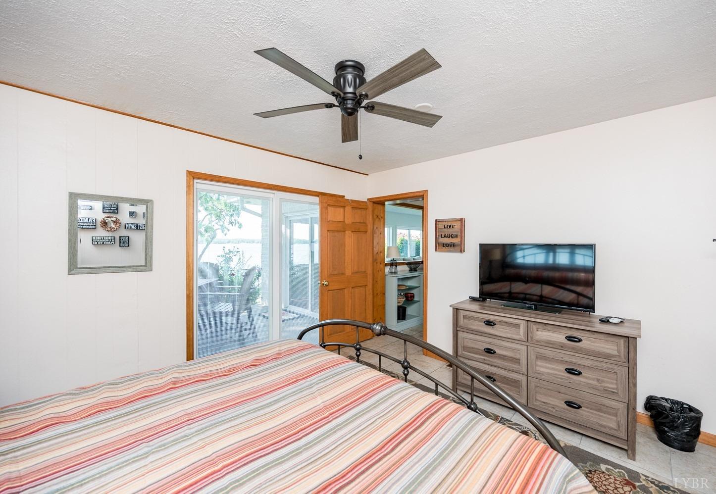 311 Anthony Home Road Huddleston, VA 24104 - Photo 32 of 70 a bedroom with a bed and a flat screen tv