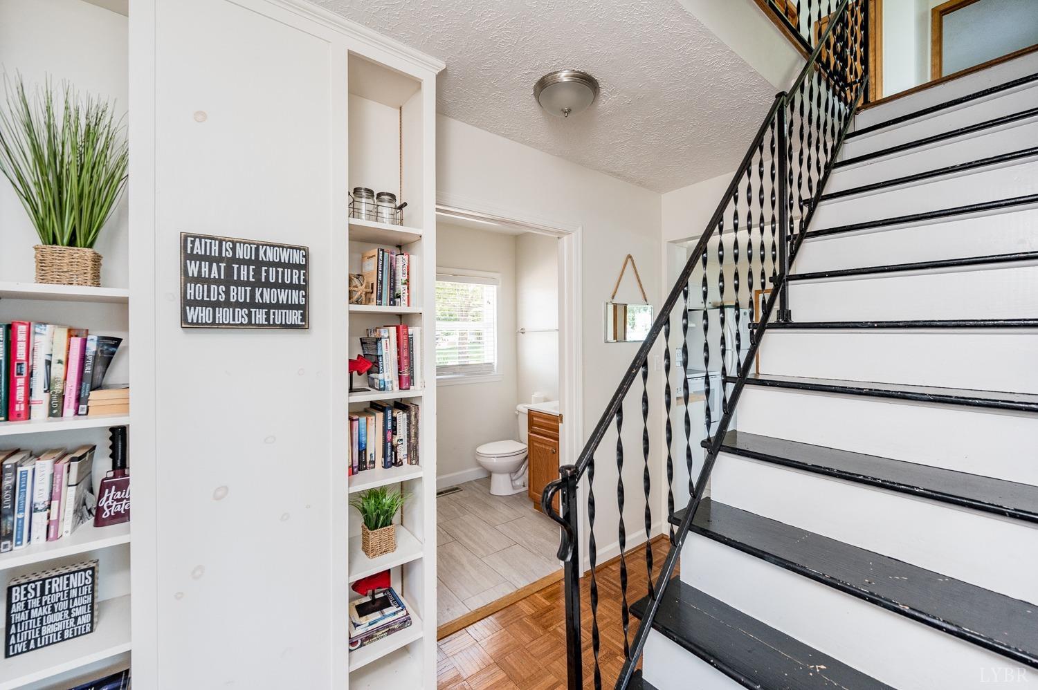 311 Anthony Home Road Huddleston, VA 24104 - Photo 49 of 70 a view of staircase with wooden floor and book shelf