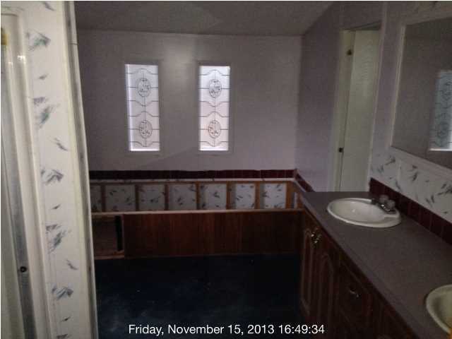 261 Don Graff Road Freeport, FL 32439 - Photo 3 of 20 a bathroom with a sink and a mirror