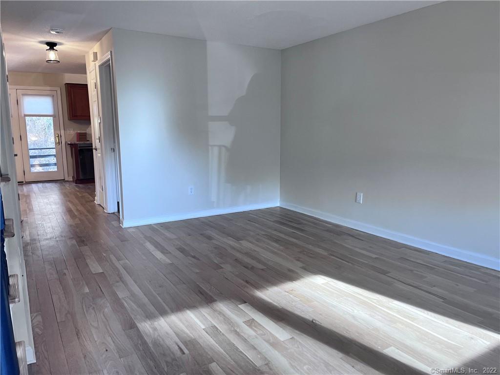 745 Greens Loop, Unit 745 Cheshire, CT 06410 - Photo 13 of 22 a view of empty room with wooden floor