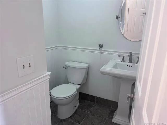 a white toilet sitting next to a bathroom sink