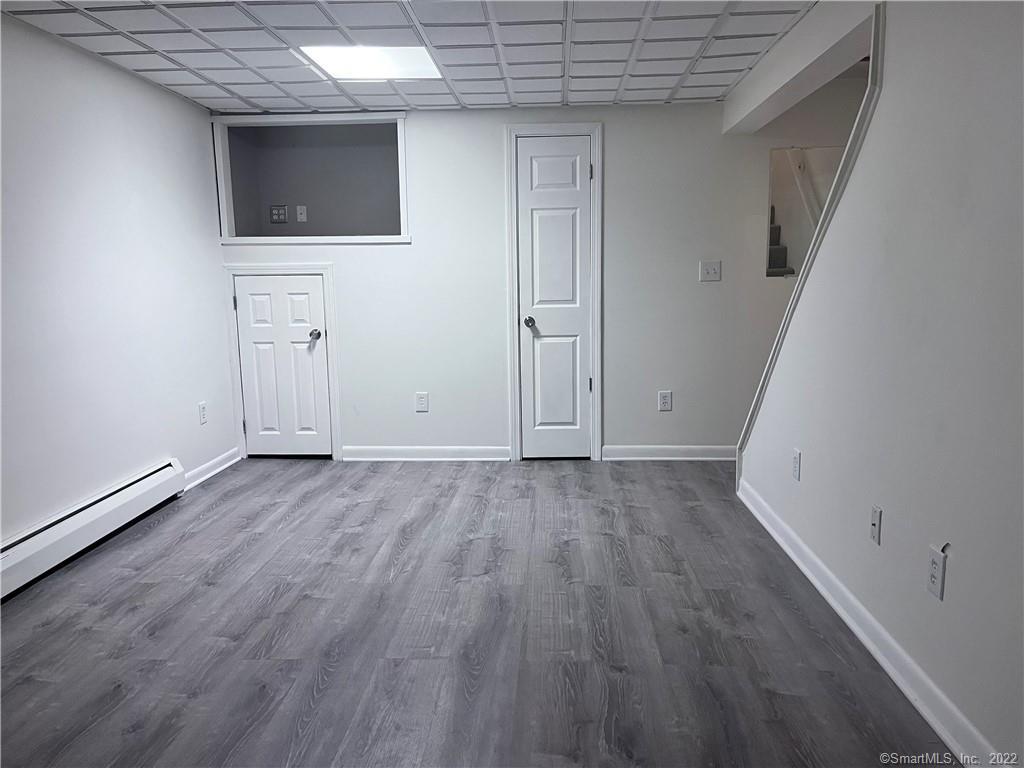 745 Greens Loop, Unit 745 Cheshire, CT 06410 - Photo 19 of 22 a view of an empty room with wooden floor and a window