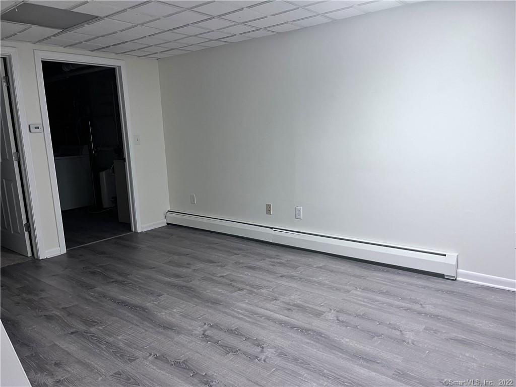745 Greens Loop, Unit 745 Cheshire, CT 06410 - Photo 20 of 22 a view of an empty room with wooden floor and closet