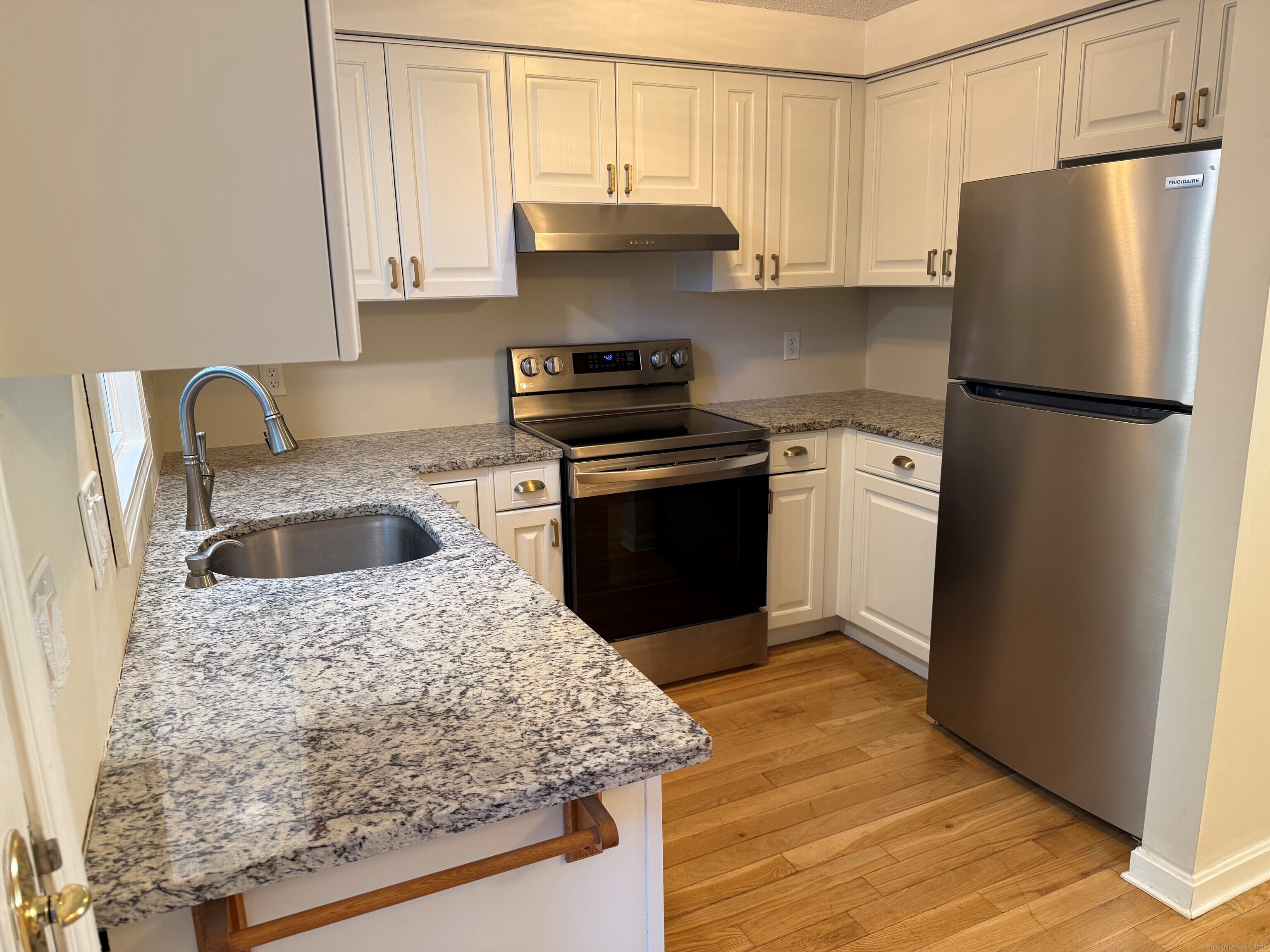 745 Greens Loop, Unit 745 Cheshire, CT 06410 - Photo 10 of 22 a kitchen with stainless steel appliances granite countertop a sink stove and refrigerator