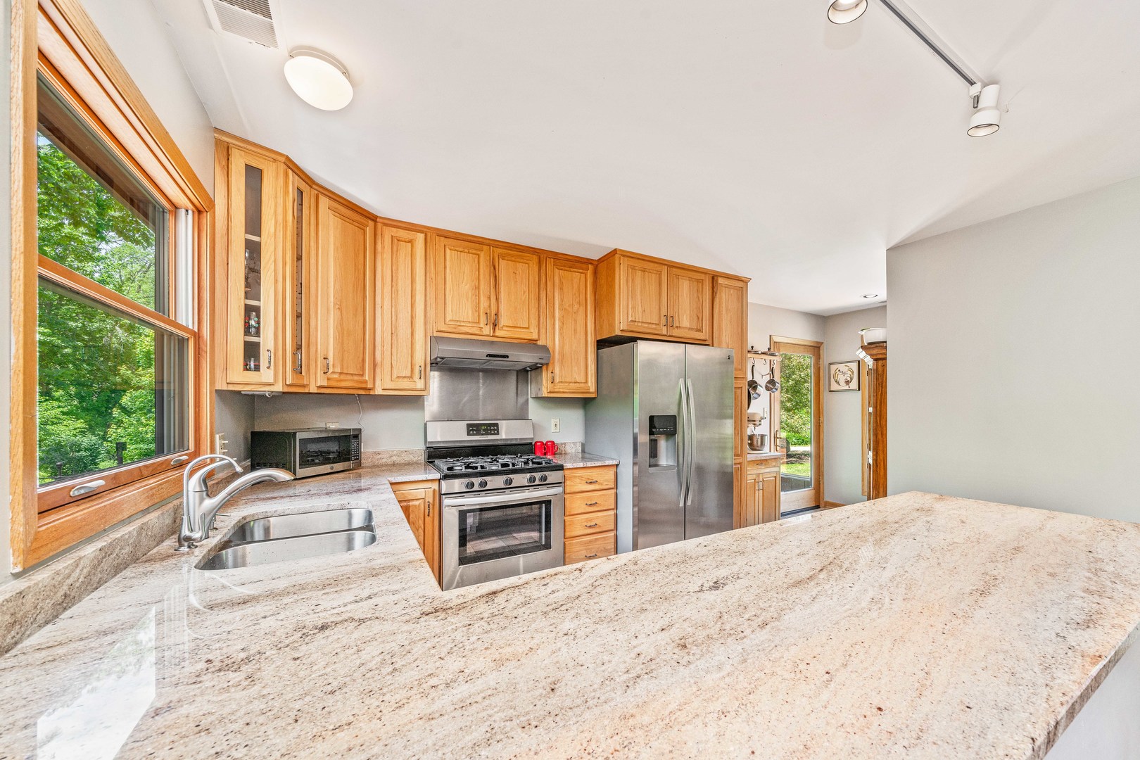 911 Melugins Grove Road Compton, IL 61318 - Photo 3 of 60 a kitchen with stainless steel appliances a stove a refrigerator and a sink