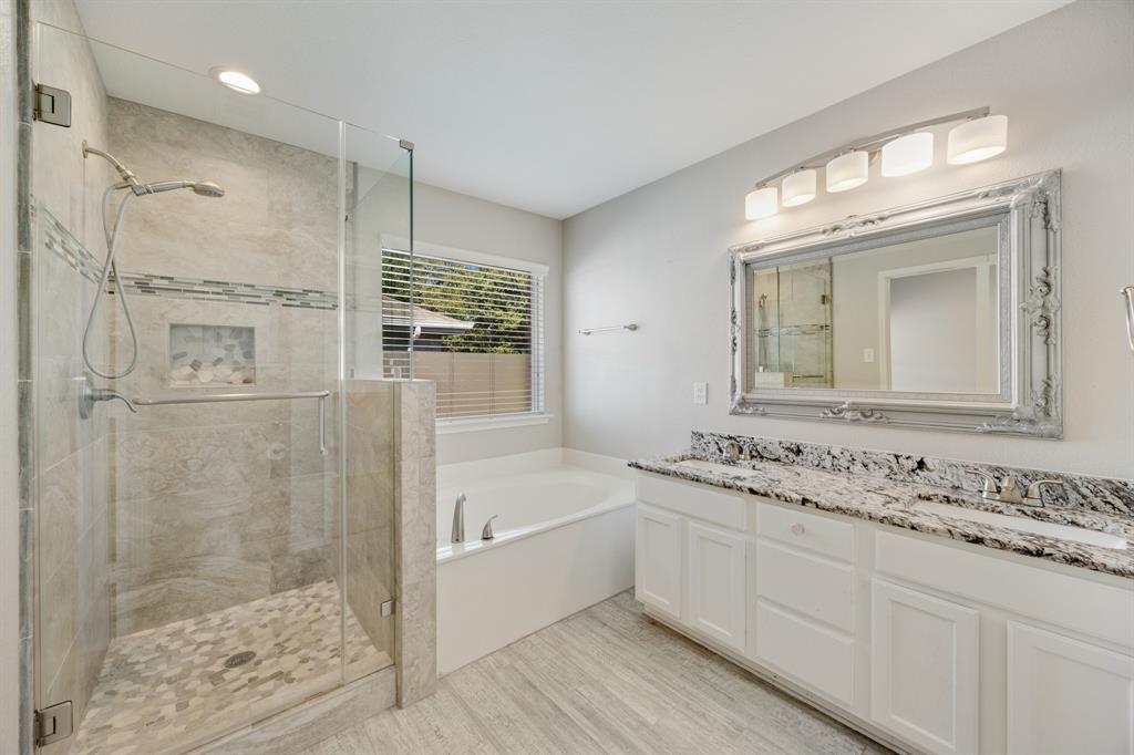 2271 Fieldcrest Drive Rockwall, TX 75032 - Photo 19 of 24 a bathroom with a granite countertop sink mirror and a bathtub