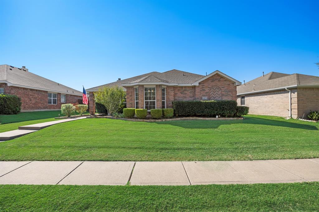 2271 Fieldcrest Drive Rockwall, TX 75032 - Photo 2 of 24 a front view of a house with a garden