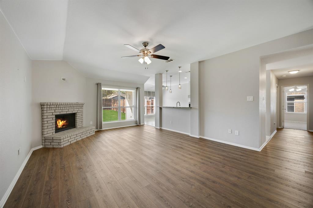 2271 Fieldcrest Drive Rockwall, TX 75032 - Photo 5 of 24 a view of an empty room with a fireplace and a window
