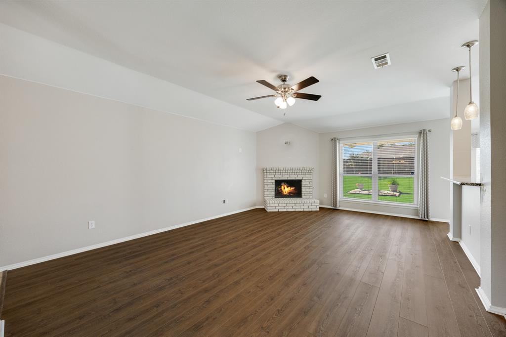 2271 Fieldcrest Drive Rockwall, TX 75032 - Photo 6 of 24 a view of an empty room with wooden floor and a window
