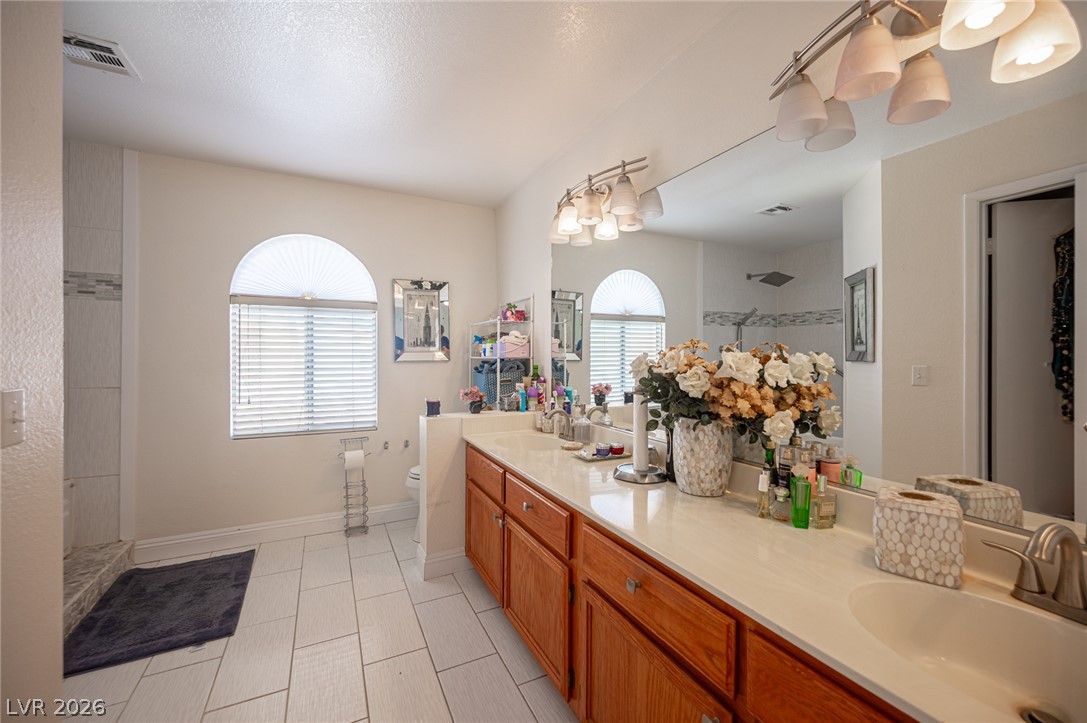 718 Rusty Spur Drive Henderson, NV 89014 - Photo 48 of 50 Ample counter space and dual vanities provide convenience in this well-appointed bathroom.