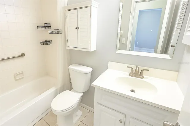 a view of an empty room with closet and a window