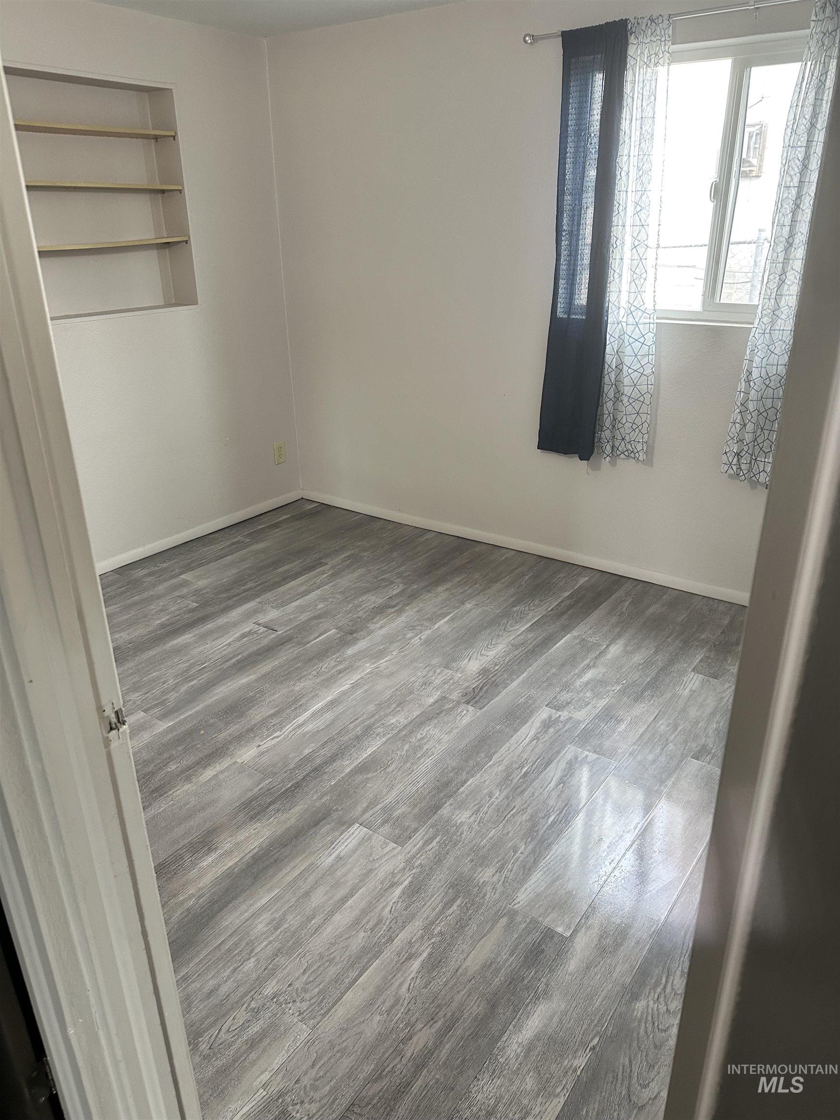 661 Southwest 3rd Street Ontario, OR 97914 - Photo 14 of 45 Unfurnished bedroom featuring dark wood-type flooring and baseboards