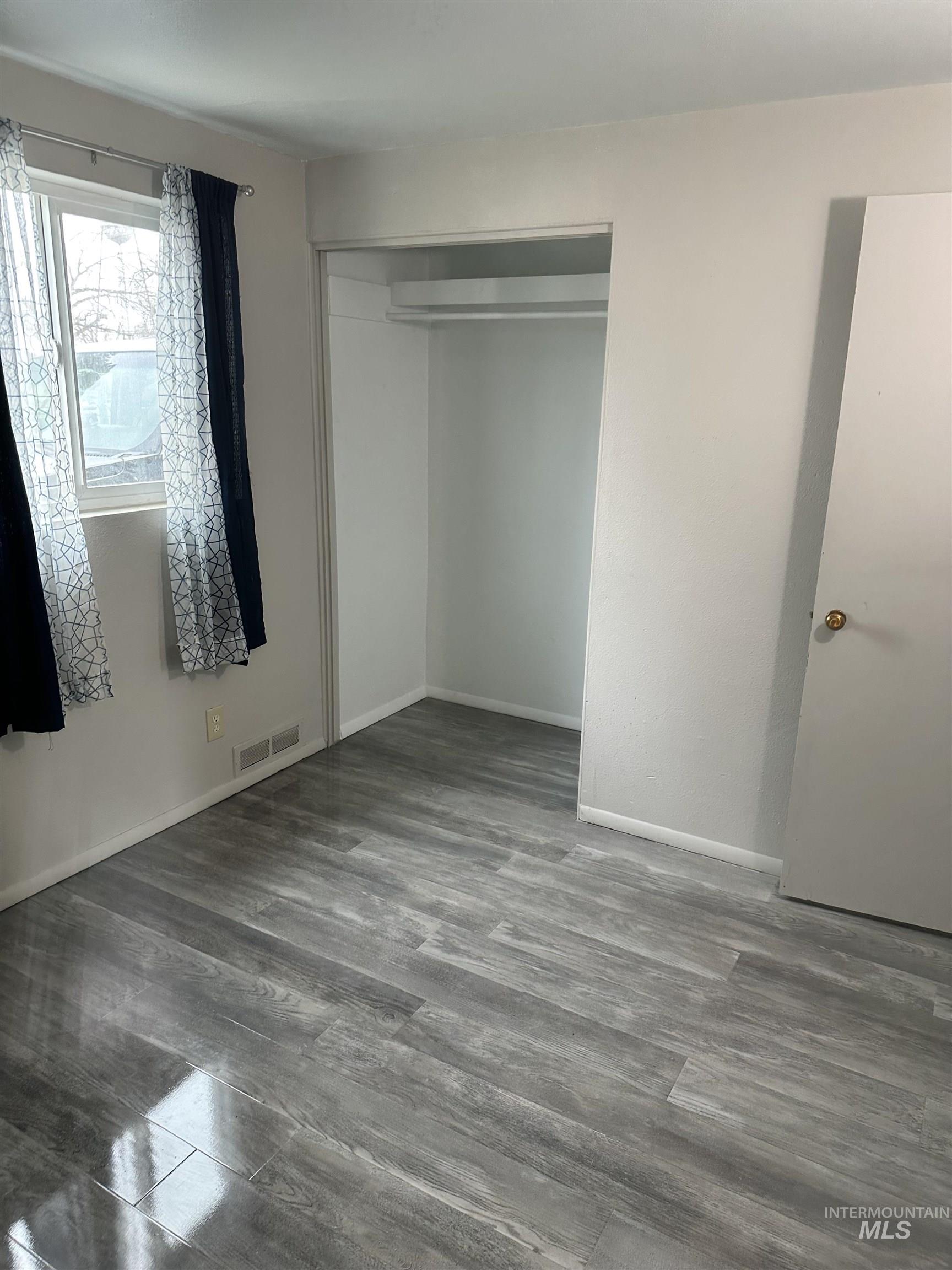 661 Southwest 3rd Street Ontario, OR 97914 - Photo 17 of 45 Unfurnished bedroom featuring dark wood-type flooring and a closet