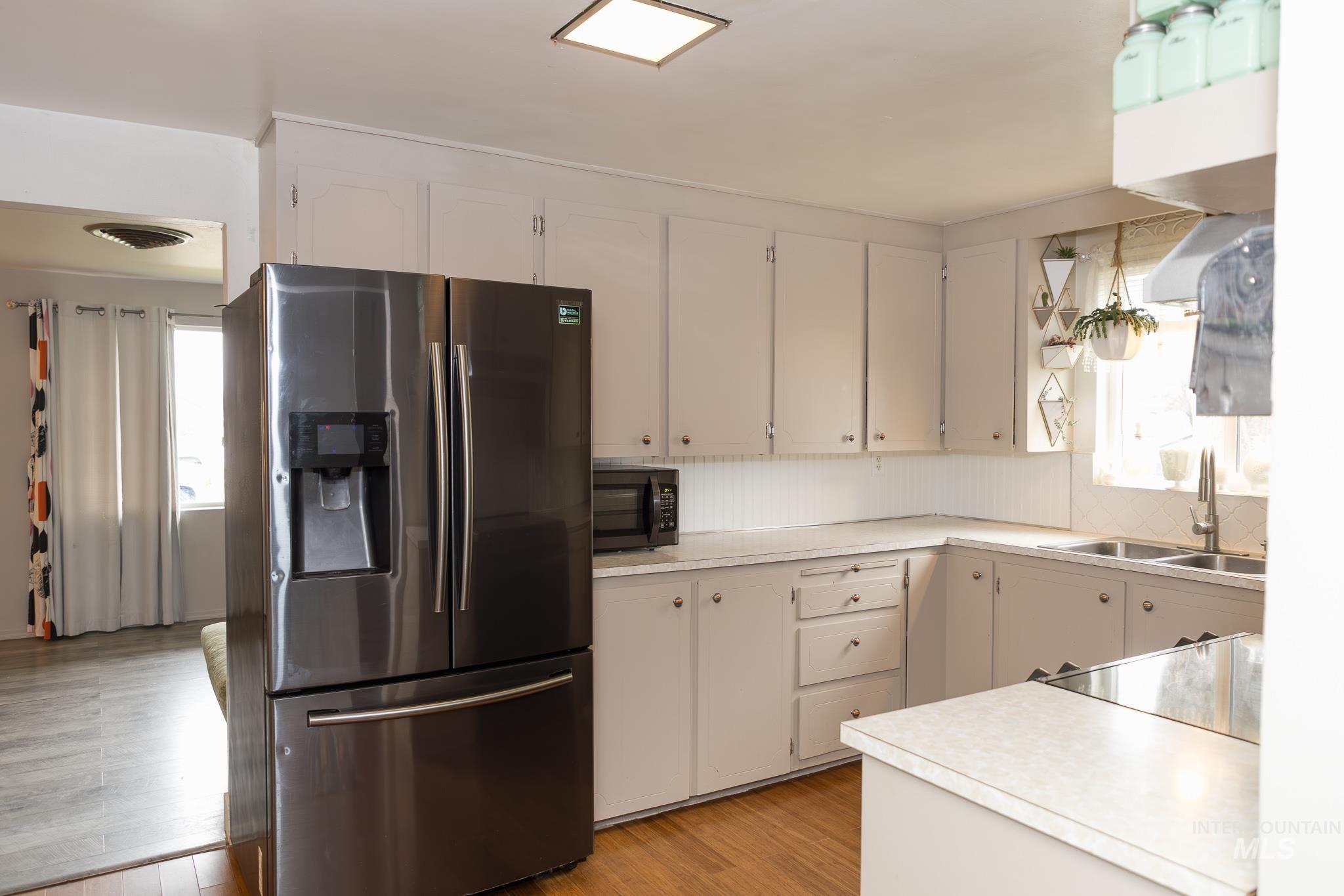 661 Southwest 3rd Street Ontario, OR 97914 - Photo 20 of 45 Kitchen with stainless steel fridge, light countertops, and light wood-style floors